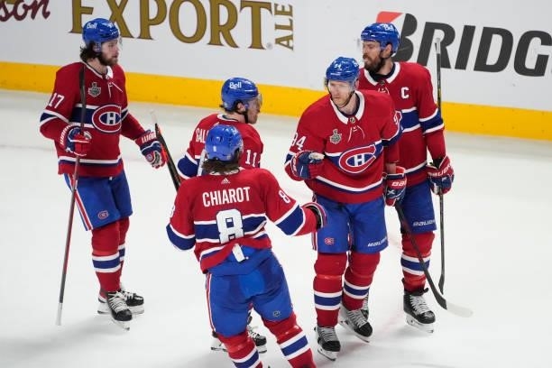 Corey Perry of the Montreal Canadiens is congratulated by his teammates after scoring a goal against the Tampa Bay Lightning during the third period...