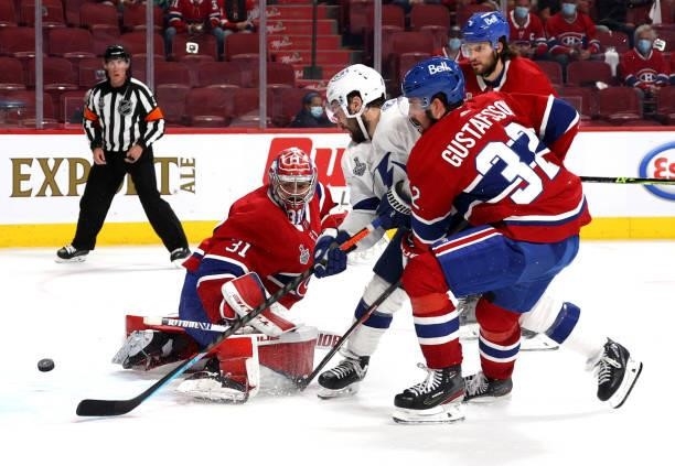 Tyler Johnson of the Tampa Bay Lightning gets the puck past goaltender Carey Price of the Montreal Canadiens en route to scoring a goal during the...