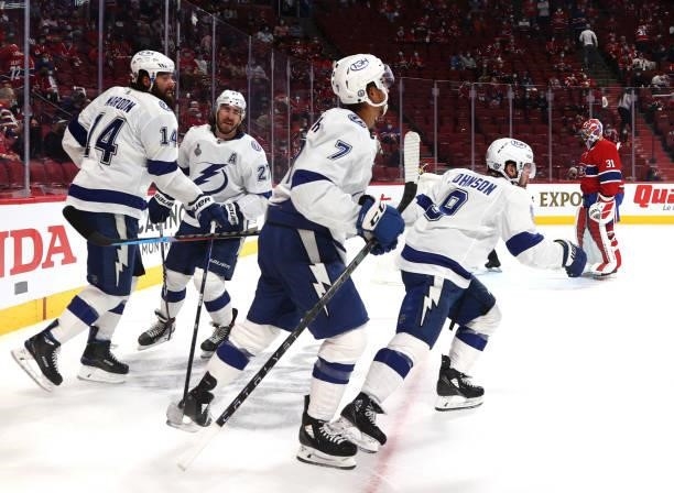 Tyler Johnson of the Tampa Bay Lightning celebrates his goal against the Montreal Canadiens with teammates during the third period of Game Three of...