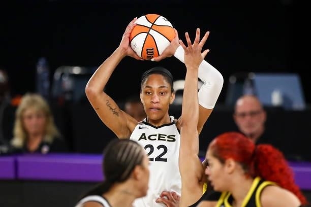 Forward A'ja Wilson of the Las Vegas Aces looks to pass the ball against the Los Angeles Sparks in the first half at the Los Angeles Convention...