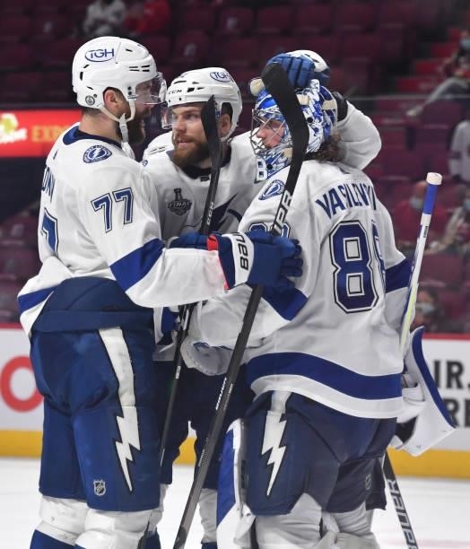 Victor Hedman, Erik Cernak, and Andrei Vasilevskiy of the Tampa Bay Lightning celebrate after defeating the Montreal Canadiens 6-3 in Game Three of...