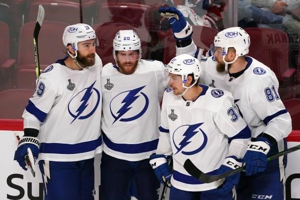 Blake Coleman of the Tampa Bay Lightning is congratulated by his teammates after scoring an empty-net goal against the Montreal Canadiens during the...