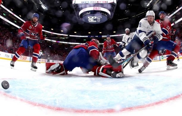 Tyler Johnson of the Tampa Bay Lightning gets the puck past goaltender Carey Price of the Montreal Canadiens en route to scoring a goal during the...