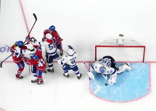 Andrei Vasilevskiy of the Tampa Bay Lightning covers the puck as his teammates scuffle with the Montreal Canadiens during the second period in Game...