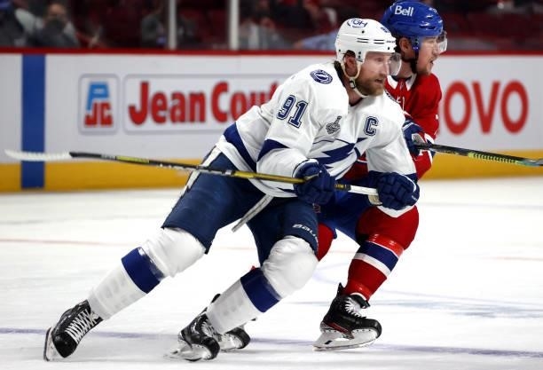 Steven Stamkos of the Tampa Bay Lightning and Tyler Toffoli of the Montreal Canadiens skate during the third period of Game Three of the 2021 Stanley...