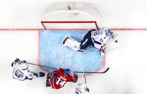 Goaltender Andrei Vasilevskiy of the Tampa Bay Lightning makes a save against Nick Suzuki of the Montreal Canadiens during the first period of Game...