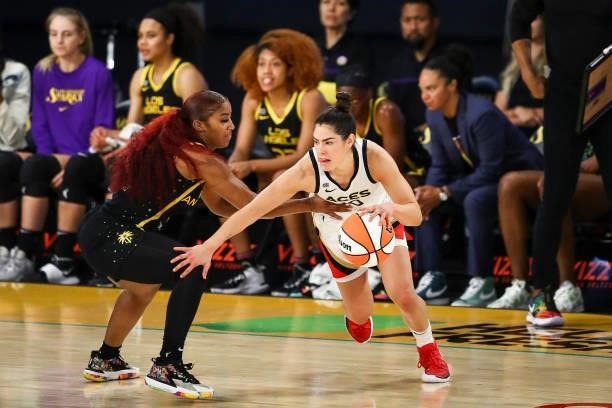Guard Kelsey Plum of the Las Vegas Aces handles the ball while defended by guard Te'a Cooper of the Los Angeles Sparks in the second half at Los...