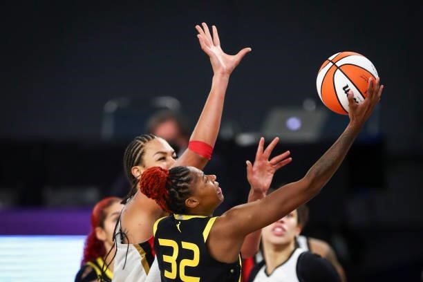 Guard Bria Holmes of the Los Angeles Sparks drives to the basket while defended by center Liz Cambage of the Las Vegas Aces at Los Angeles Convention...