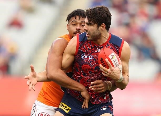 Christian Petracca of the Demons is challenged by Connor Idun of the Giants during the round 16 AFL match between Melbourne Demons and Greater...