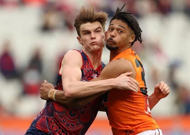 Bayley Fritsch of the Demons and Connor Idun of the Giants compete for the ball during the round 16 AFL match between Melbourne Demons and Greater...