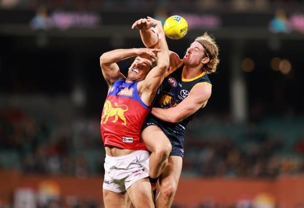 Brandon Starcevich of the Lions and Sam Berry of the Crows compete for the ball during the round 16 AFL match between Adelaide Crows and Brisbane...