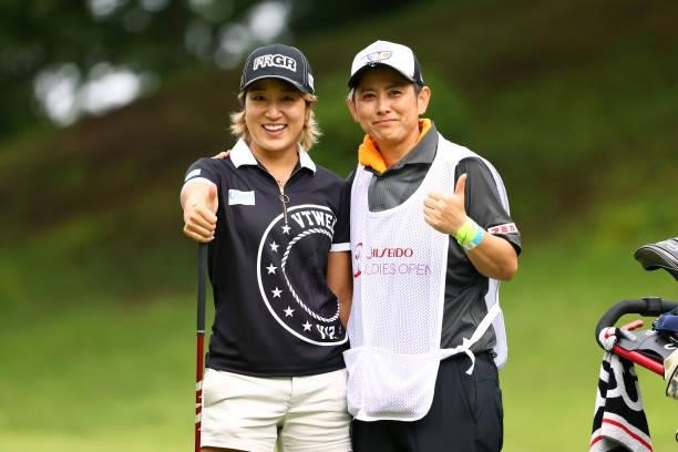 Asako Fujimoto of Japan poses with her caddie on the 2nd tee during the first round of the Shiseido Ladies Open at Totsuka Country Club on July 3,...