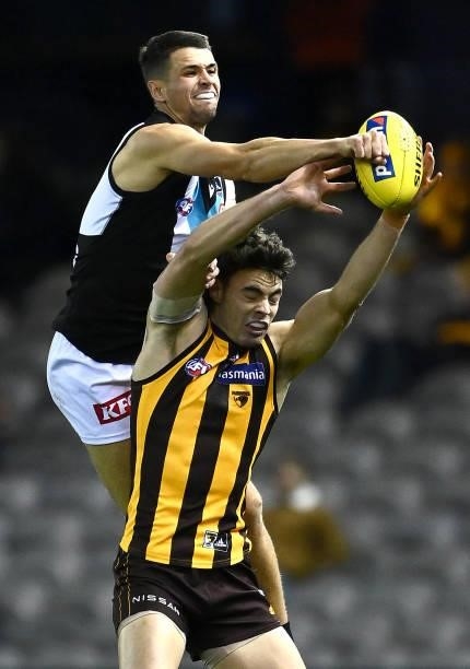 Ryan Burton of the Power spoils a mark by Conor Nash of the Hawks during the round 16 AFL match between Hawthorn Hawks and Port Adelaide Power at...