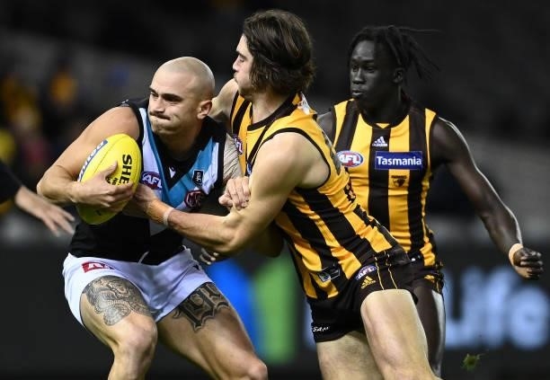 Sam Powell-Pepper of the Power is tackled by Jai Newcombe of the Hawks during the round 16 AFL match between Hawthorn Hawks and Port Adelaide Power...