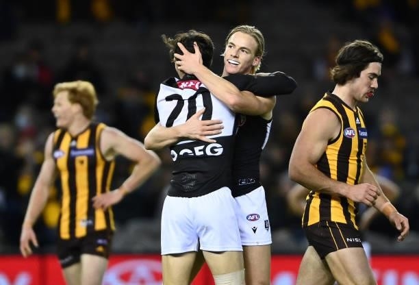 Miles Bergman of the Power is congratulated by Connor Rozee after kicking a goal during the round 16 AFL match between Hawthorn Hawks and Port...