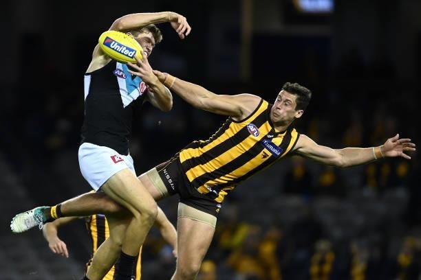 Mitch Georgiades of the Power and Kyle Hartigan of the Hawks compete for a mark during the round 16 AFL match between Hawthorn Hawks and Port...