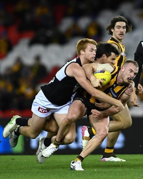 Tom Mitchell of the Hawks is tackled during the round 16 AFL match between Hawthorn Hawks and Port Adelaide Power at Marvel Stadium on July 03, 2021...