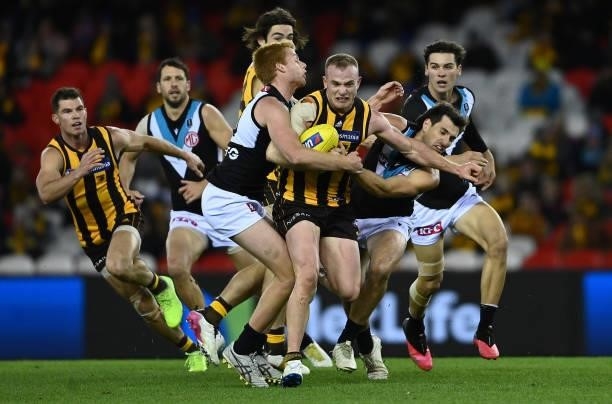 Tom Mitchell of the Hawks is tackled during the round 16 AFL match between Hawthorn Hawks and Port Adelaide Power at Marvel Stadium on July 03, 2021...