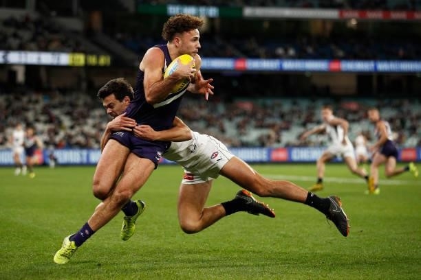 Griffin Logue of the Dockers is tackled by Jack Silvagni of the Blues during the round 16 AFL match between Fremantle Dockers and Carlton Blues at...
