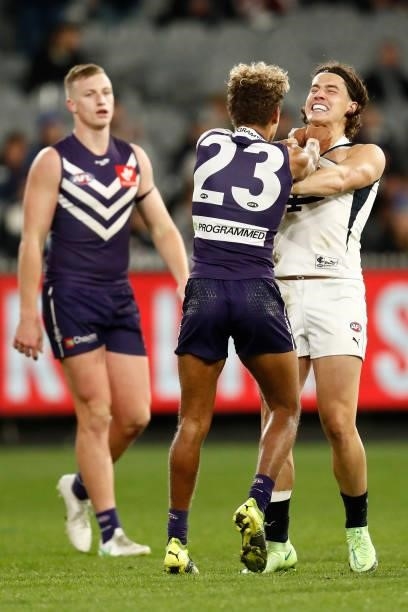 Liam Stocker of the Blues and Liam Henry of the Dockers wrestle during the round 16 AFL match between Fremantle Dockers and Carlton Blues at the...