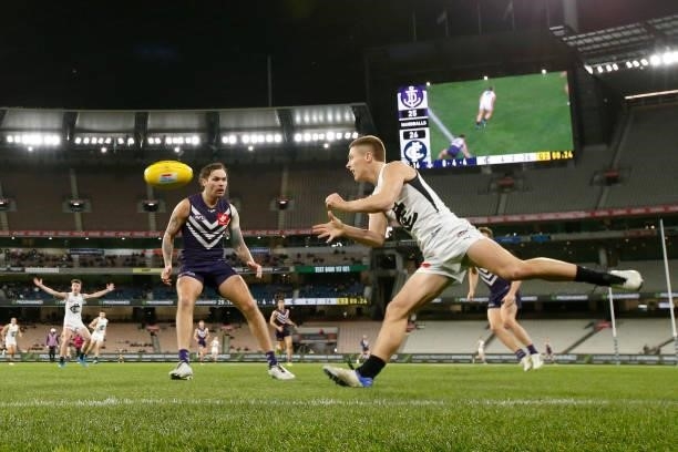 Lachie Fogarty of the Blues handballs during the round 16 AFL match between Fremantle Dockers and Carlton Blues at the Melbourne Cricket Ground on...
