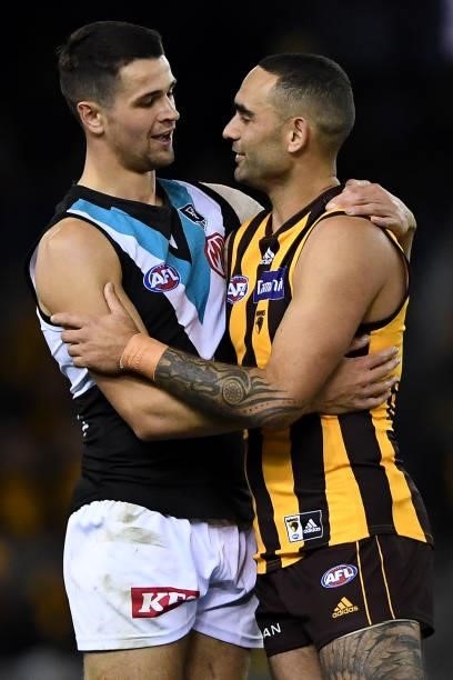 Ryan Burton of the Power and Shaun Burgoyne of the Hawks hug at the end of the match during the round 16 AFL match between Hawthorn Hawks and Port...
