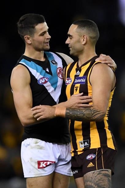 Ryan Burton of the Power and Shaun Burgoyne of the Hawks hug at the end of the match during the round 16 AFL match between Hawthorn Hawks and Port...