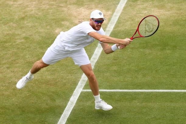 Jamie Murray of Great Britain plays a forehand alongside partner Bruno Soares of Brazil during their men's doubles second round match against Andrey...