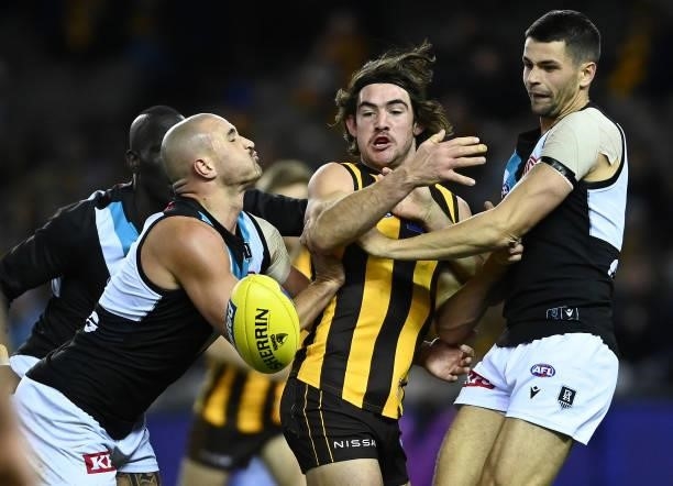 Jai Newcombe of the Hawks is tackled by Sam Powell-Pepper of the Power during the round 16 AFL match between Hawthorn Hawks and Port Adelaide Power...