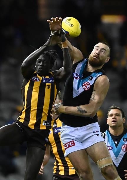 Changkuoth Jiath of the Hawks and Charlie Dixon of the Power compete for a mark during the round 16 AFL match between Hawthorn Hawks and Port...