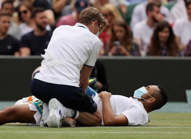 Nick Kyrgios of Australia receives treatment during his men's singles third round match against Felix Auger Aliassime of Canada during Day Six of The...