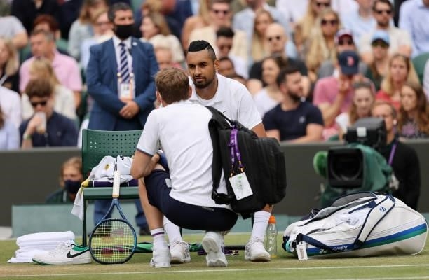 Nick Kyrgios of Australia receives treatment as he retire's injured during his men's singles third round match against Felix Auger Aliassime of...