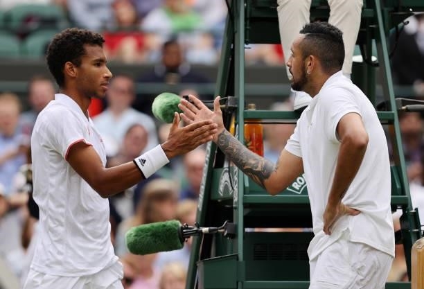 Nick Kyrgios of Australia interacts with Felix Auger Aliassime of Canada after pulling out injured during the men's singles third round match during...