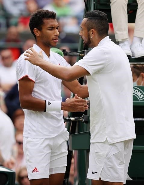 Nick Kyrgios of Australia interacts with Felix Auger Aliassime of Canada after pulling out injured during the men's singles third round match during...
