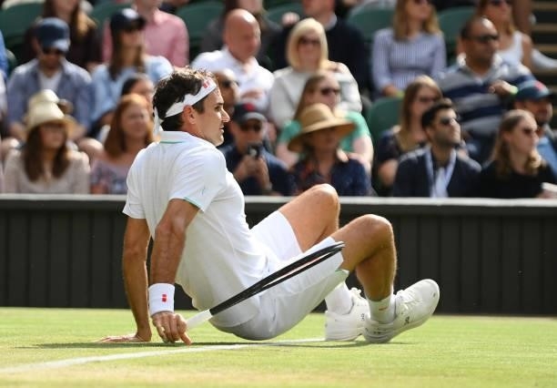 Roger Federer of Switzerland slips over during his men's singles third round match against Cameron Norrie of Great Britain during Day Six of The...