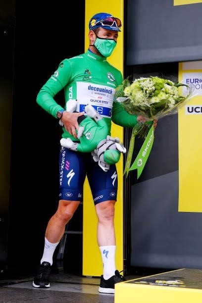 Mark Cavendish of The United Kingdom and Team Deceuninck - Quick-Step Green Points Jersey celebrates at podium during the 108th Tour de France 2021,...