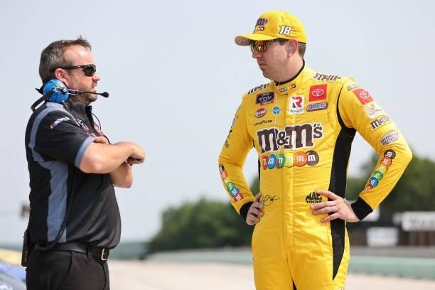 Kyle Busch, driver of the M&M's Ice Cream Toyota, speaks with a crew member during the NASCAR Xfinity Series Henry 180 at Road America on July 03,...