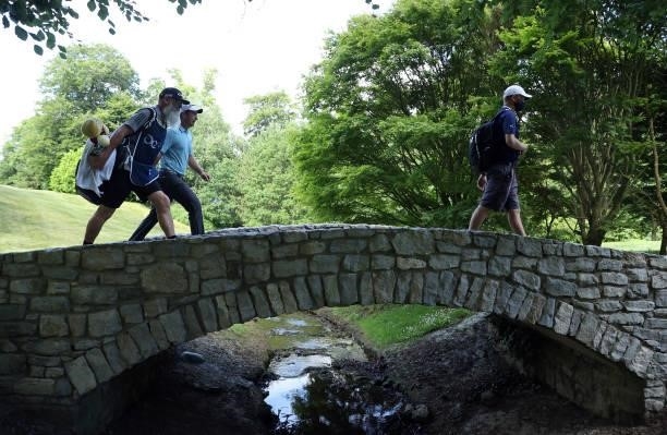 Lucas Herbert of Australia crosses the bridge on the 14th hole with his caddie Nick Pugh during Day Three of The Dubai Duty Free Irish Open at Mount...