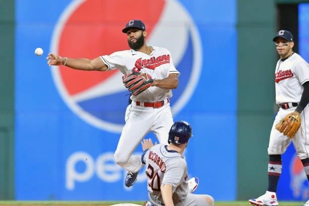 Shortstop Amed Rosario of the Cleveland Indians throws out Taylor Jones at first as Chas McCormick of the Houston Astros is out at second for a...