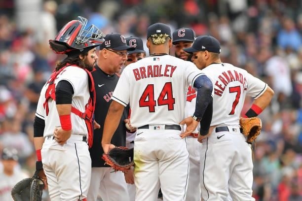 Terry Francona of the Cleveland Indians talks with his infielders during a pitching change during the fourth inning against the Houston Astros at...