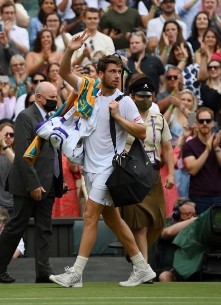 Cameron Norrie of Great Britain walks off court after defeat in his men's singles third round match against Roger Federer of Switzerland during Day...