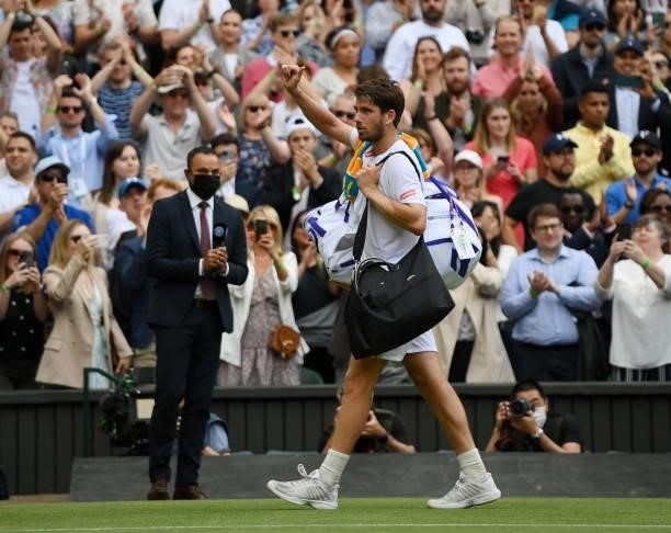 Cameron Norrie of Great Britain walks off court after defeat in his men's singles third round match against Roger Federer of Switzerland during Day...