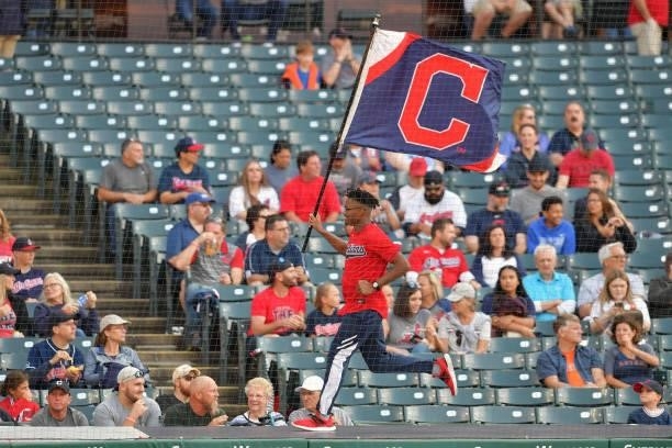 Cleveland Indians employee runs with a flag displaying the block C logo prior to the game against the Houston Astros at Progressive Field on July 02,...