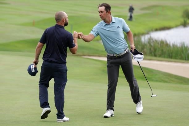 Lucas Herbert of Australia fist bumps playing partner Andy Sullivan of England on the 18th green during Day Three of The Dubai Duty Free Irish Open...