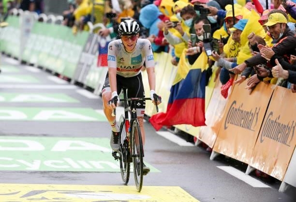 Tadej Pogacar of Slovenia and UAE Team Emirates crosses the finish line during stage 8 of the 108th Tour de France 2021, a stage of 151 km between...