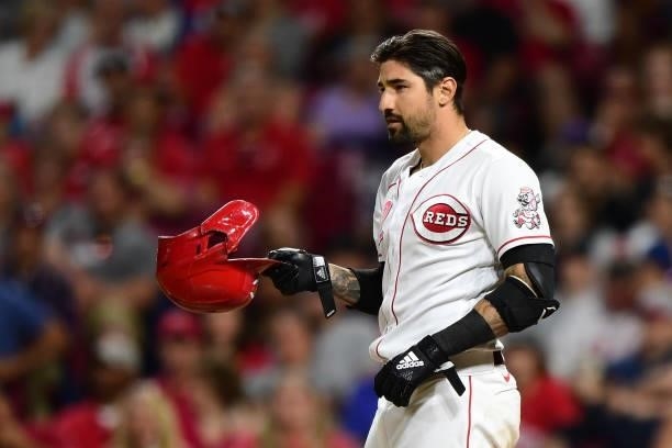Nick Castellanos of the Cincinnati Reds takes off his helmet during a game between the Chicago Cubs and Cincinnati Reds at Great American Ball Park...