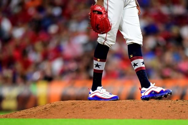 Detailed view of the patriotic cleats and socks of Amir Garrett of the Cincinnati Reds during a game between the Chicago Cubs and Cincinnati Reds at...