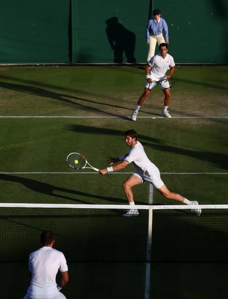 Cameron Norrie of Great Britain plays a backhand alongside partner Jaume Munar of Spain during their men's doubles second round match against Filip...