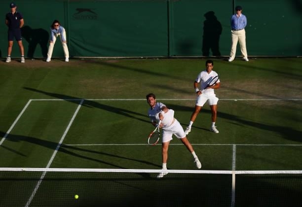 Cameron Norrie of Great Britain plays a forehand alongside partner Jaume Munar of Spain during their men's doubles second round match against Filip...