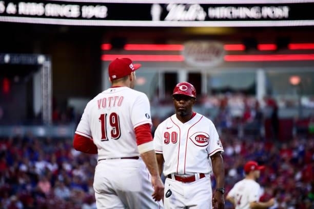 Delino DeShields and Joey Votto of the Cincinnati Reds look on during a game between the Chicago Cubs and Cincinnati Reds at Great American Ball Park...